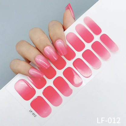 Sheet of 16 small design nail art stickers including cross, rose, tulip and marble patterns.