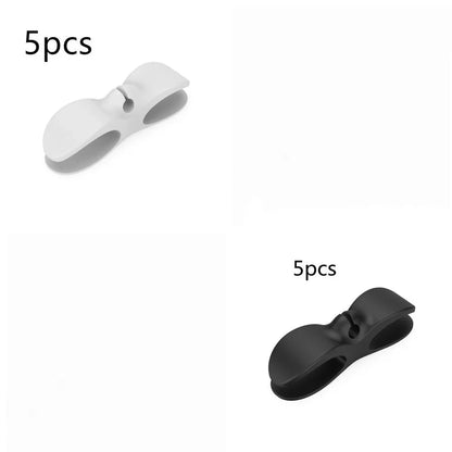 Black TPU cable organizer clips winding appliance cords on kitchen counter, 5cm size, non-marking adhesive for tidy management
