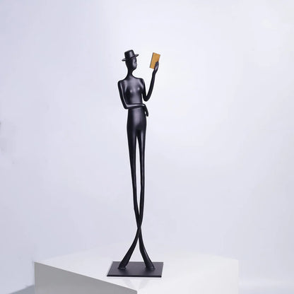 Black cast aluminium desktop sculpture of reading woman measuring 12x12x51cm with modern simplicity design