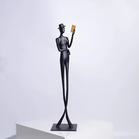 Black cast aluminium desktop sculpture of reading woman measuring 12x12x51cm with modern simplicity design