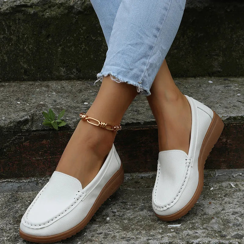 Women's flat shoes with car suture detailing on PU leather upper, round toe, rubber sole, available in multiple colours