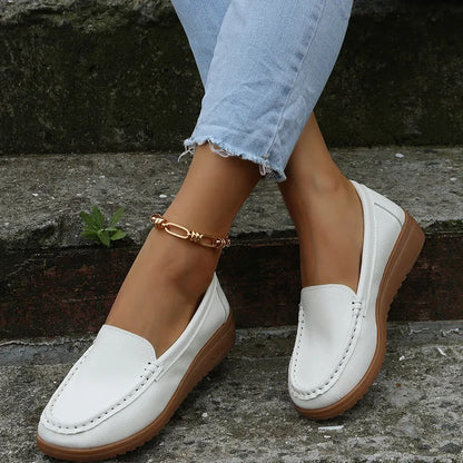 Women's flat shoes with car suture detailing on PU leather upper, round toe, rubber sole, available in multiple colours