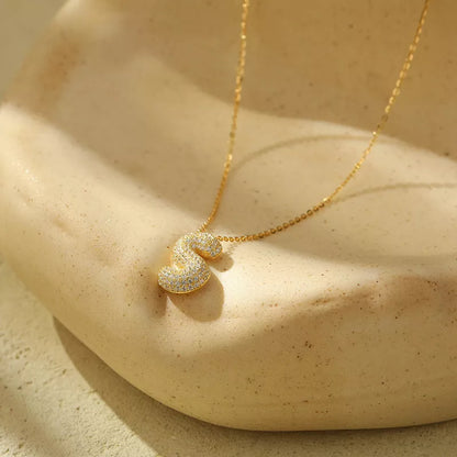 Stainless steel initial pendant necklace with zircon accents, personalized with your choice of letter.