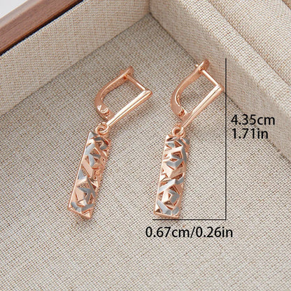 Rectangular two-tone hollow stud earrings with a geometric design and electroplated finish.
