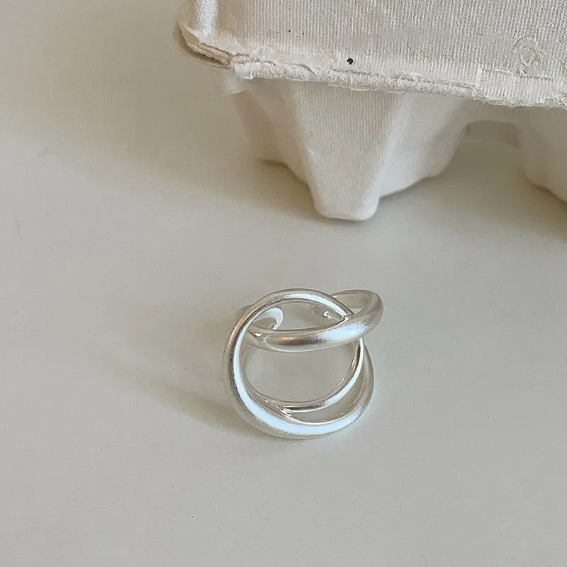 Geometric open ring with interlaced pattern and matte finish, adjustable for finger sizes 16mm to 20mm
