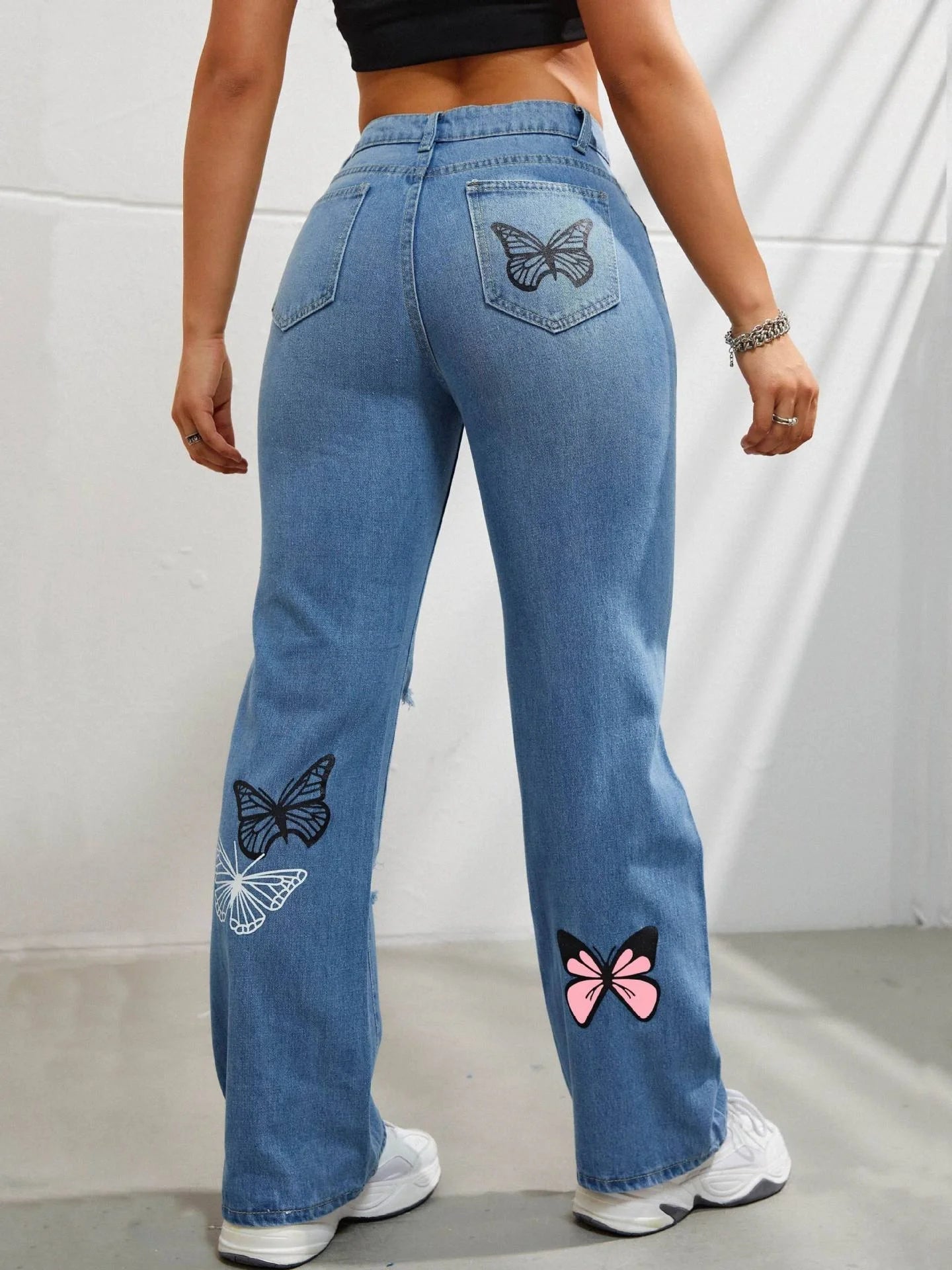 Women's high waisted straight leg jeans with butterfly print and distressed details
