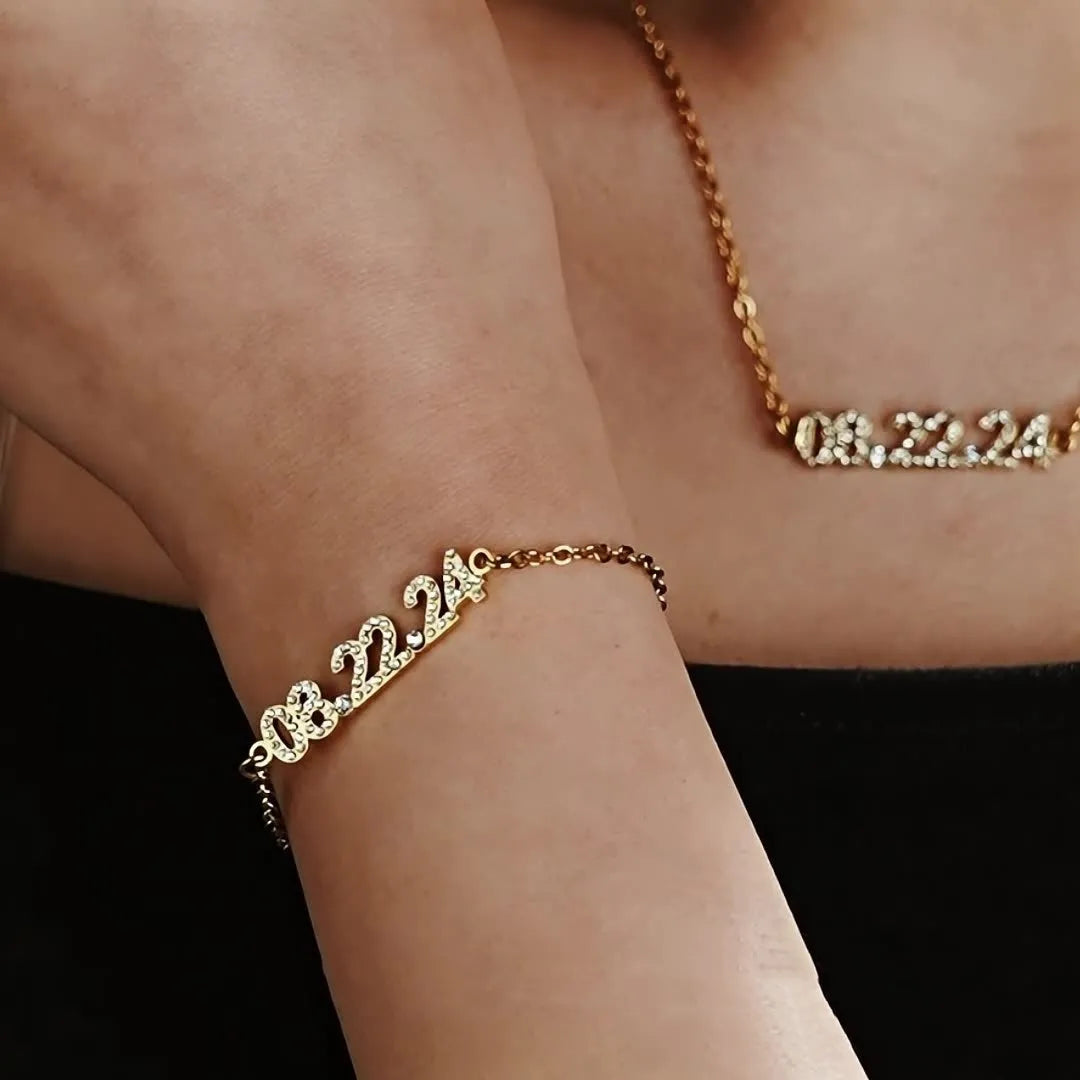 Stainless steel digital bracelet with diamond-set numbers showing time display in gold finish