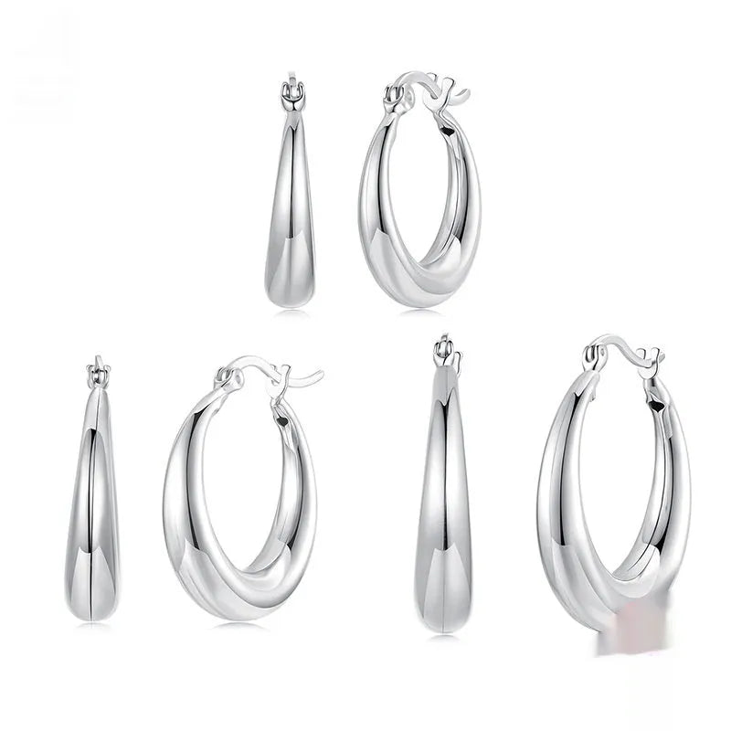 Copper alloy ear clip earrings with geometric ring design and silver posts in three sizes.