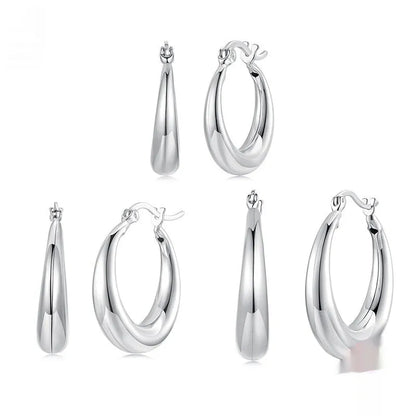 Copper alloy ear clip earrings with geometric ring design and silver posts in three sizes.