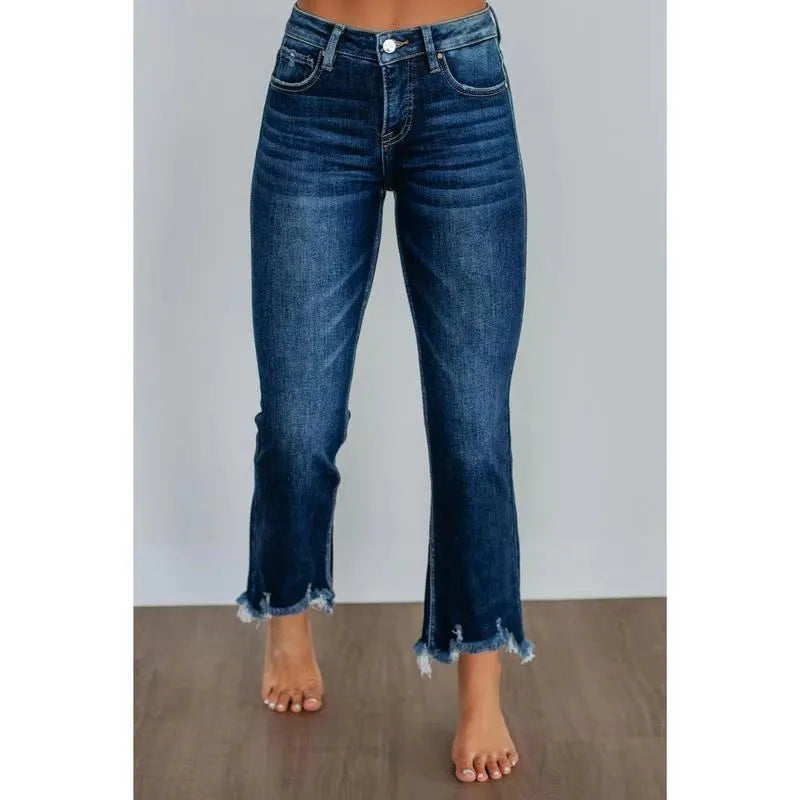 Women's solid colour denim trousers with hand-worn finish in dark blue, showing casual styling and 100% cotton construction