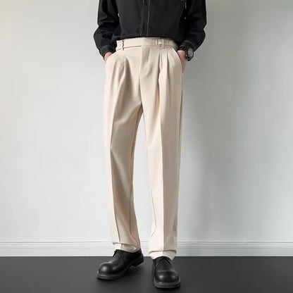 Men's apricot and black straight-leg loose fit suit trousers on a hanger.
