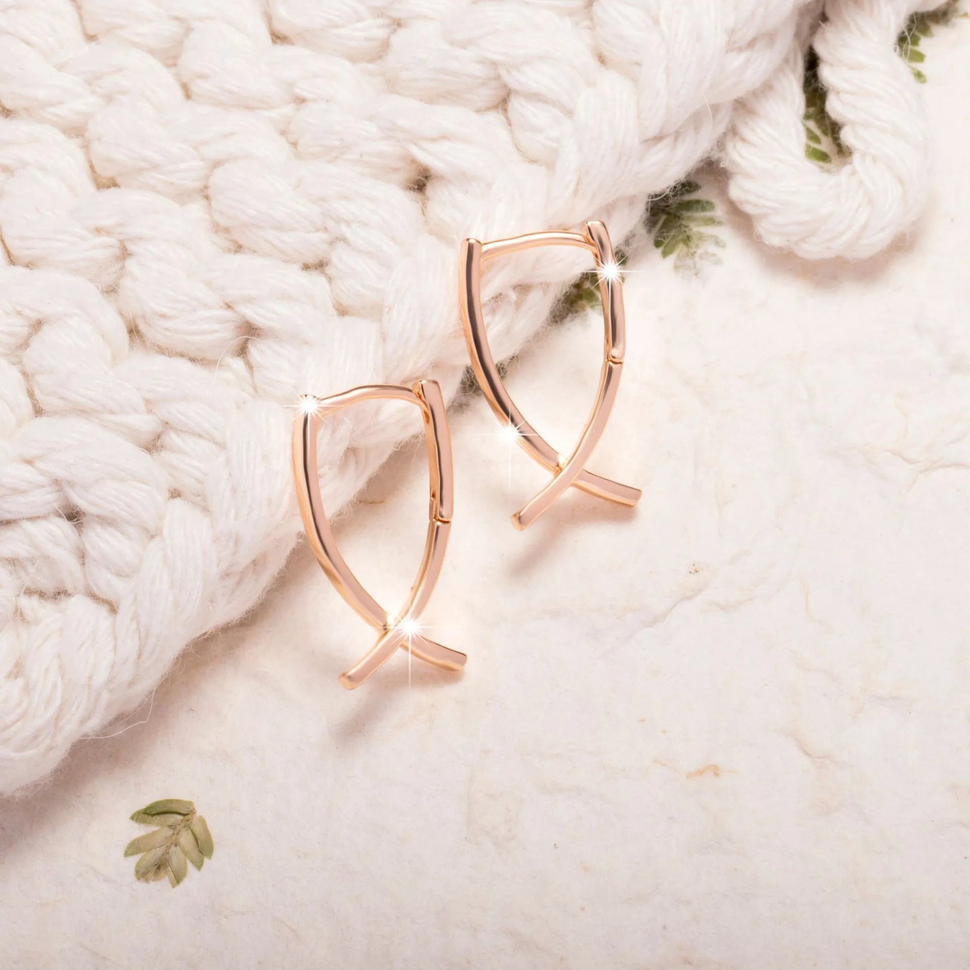 Cross-shaped copper earrings with rose gold finish, showing dimensions and post closure