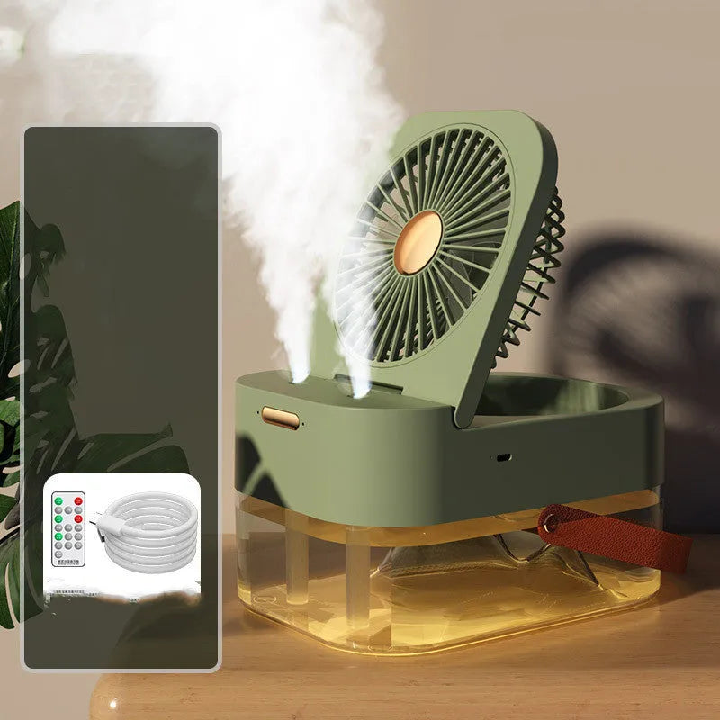White or green USB desktop mist fan with large water tank, remote control, and dual spray nozzles on a desk.