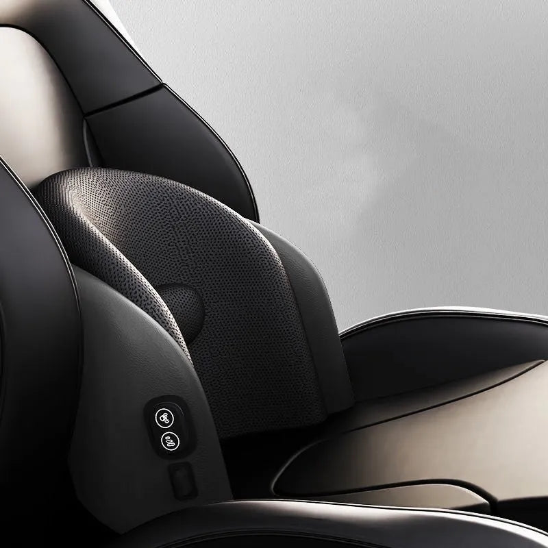 Black car massage cushion with adjustable straps attached to a car seat headrest