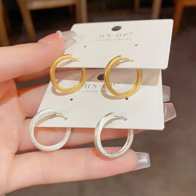 Women's geometric ear clip with round eyelet design featuring simple style fashion jewellery made from copper with real gold plating available in gold and silver colours for female wearers