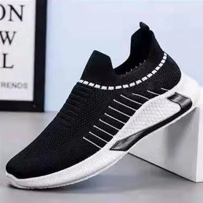 Men's black and white striped mesh slip-on sneakers with lace-up front.