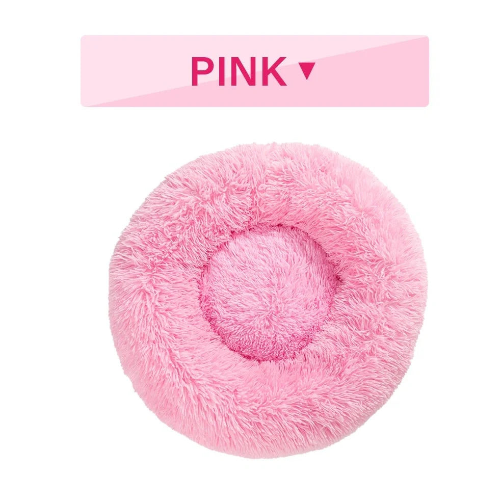 Fluffy donut-shaped dog bed in dark grey colour with raised edges, showing plush texture and circular design