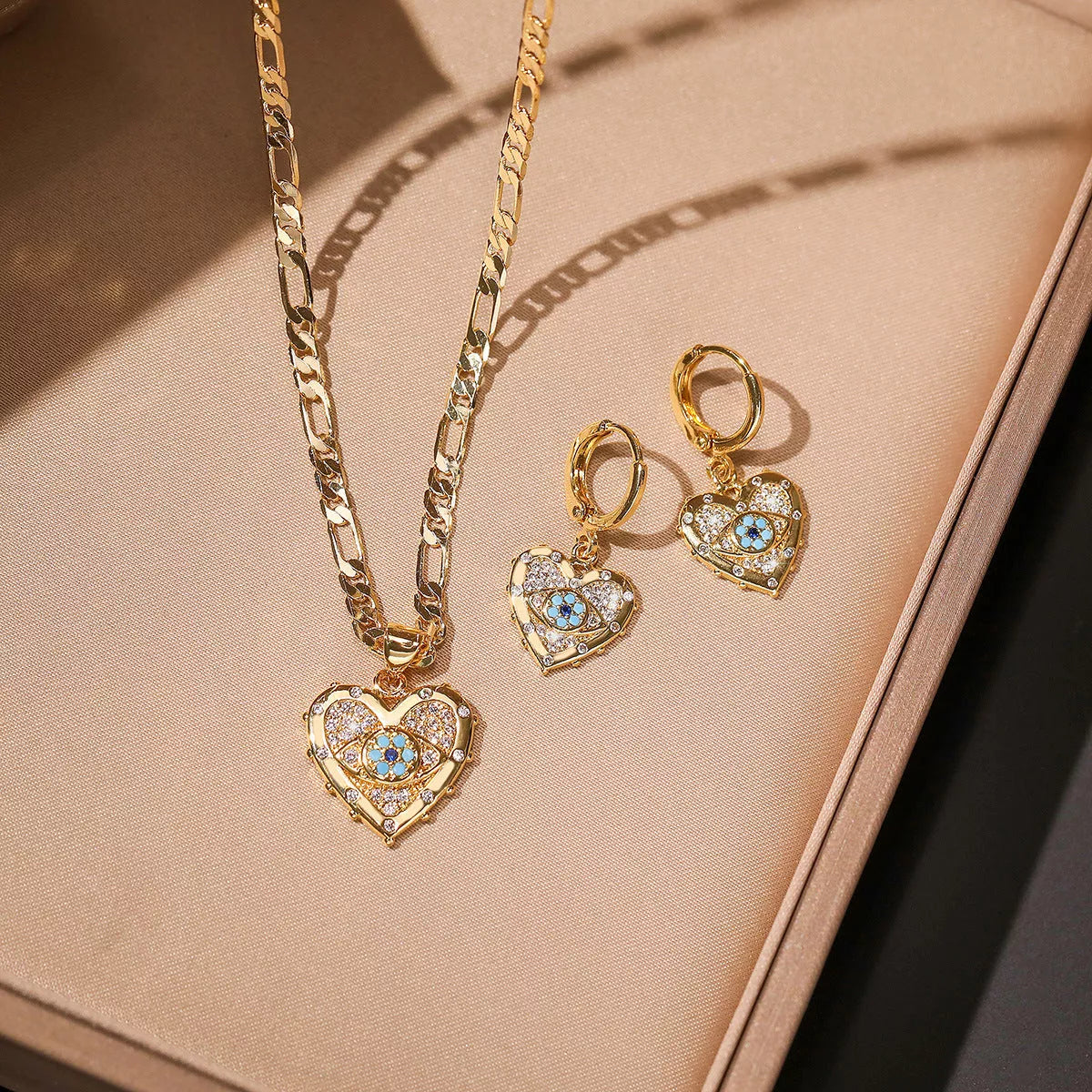 Heart-shaped zircon pendant and earrings set with copper plating and real gold accents