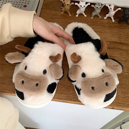 White cow-themed plush slippers with a non-slip textured sole for women.