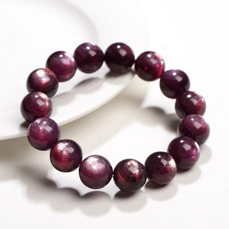 Purple lepidolite crystal bracelet with polished round beads in geometric design on wrist
