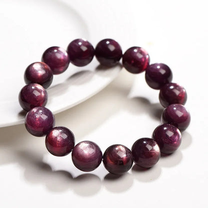 Purple lepidolite crystal bracelet with polished round beads in geometric design on wrist
