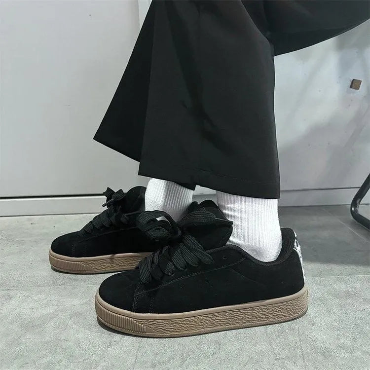 Black retro low-top sneakers with round toe, lace-up front, and a waterproof platform sole.