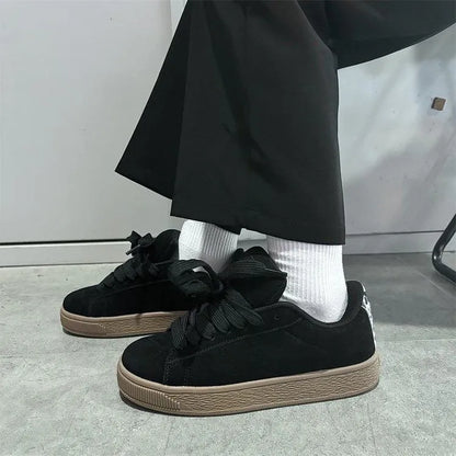 Black retro low-top sneakers with round toe, lace-up front, and a waterproof platform sole.