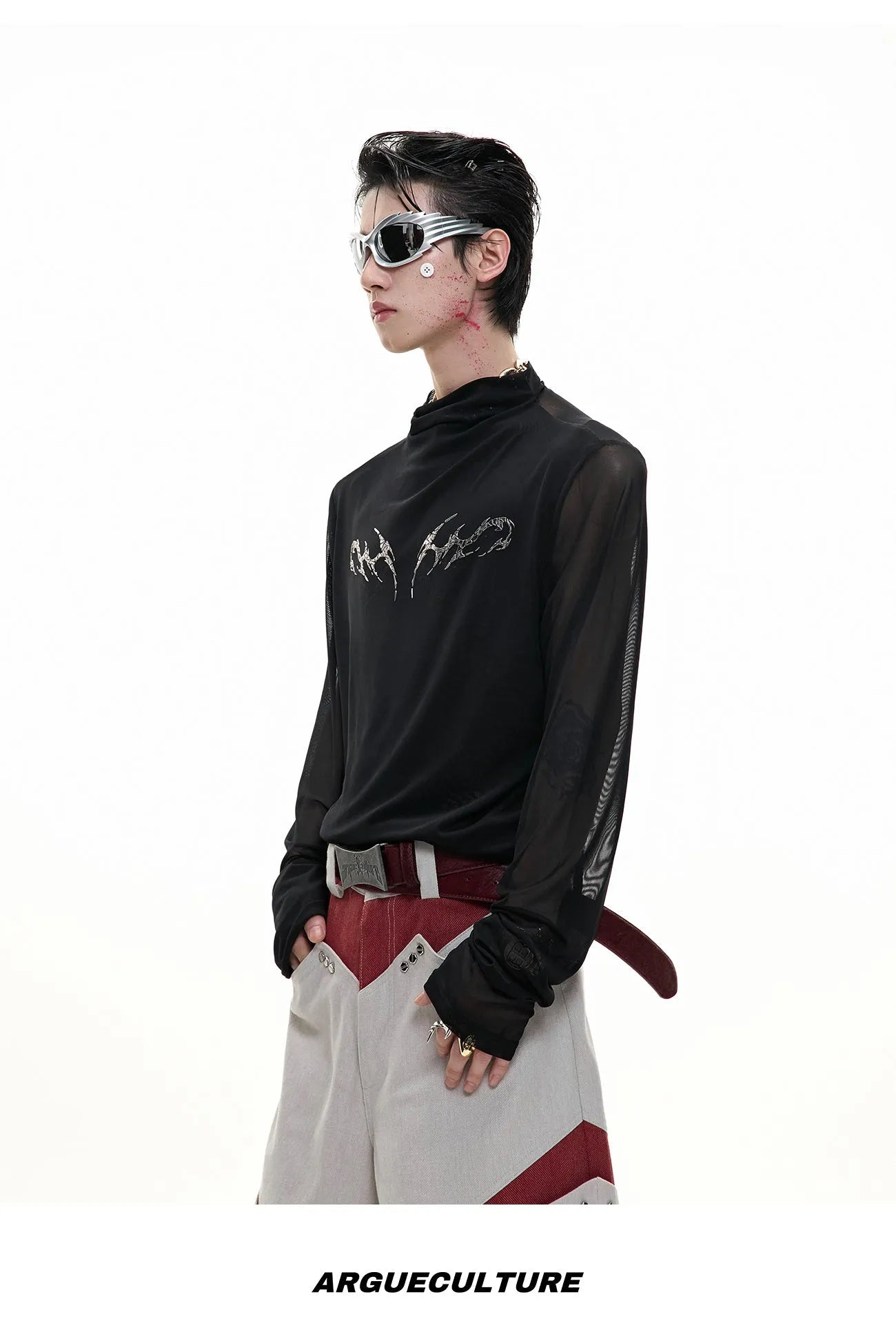 Man wearing a black slim-fit niche mesh long sleeve base layer shirt.