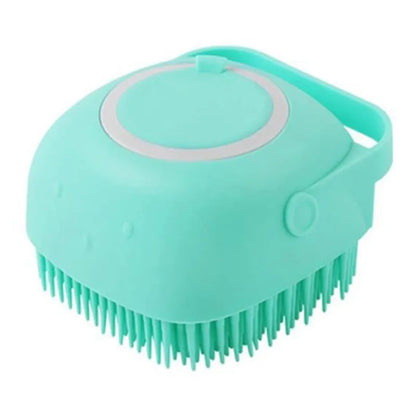 Blue silicone dog bath and massage brush held in a hand.