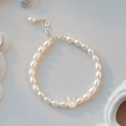 White pearl bead bracelet with silver rabbit charm on elastic string