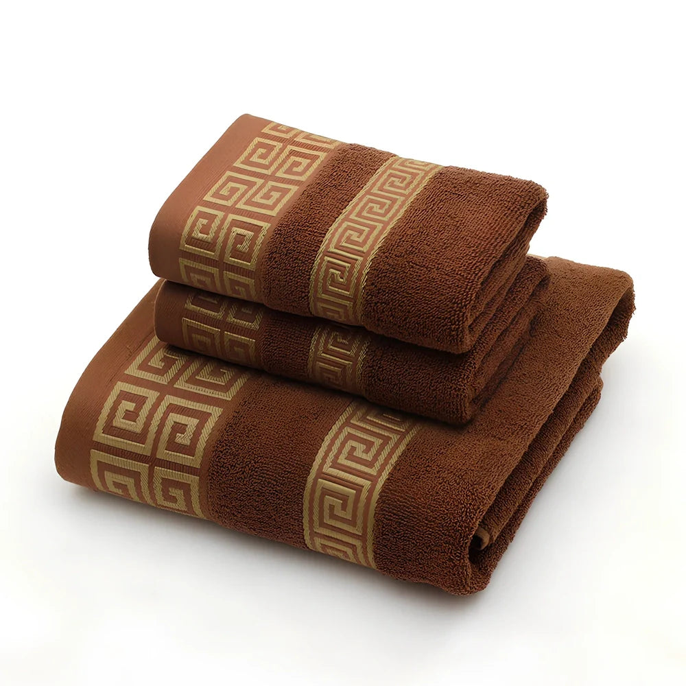 Three-piece cotton towel set showing 70cm bath towel and two 34cm hand towels in white, dark blue, and brown colours