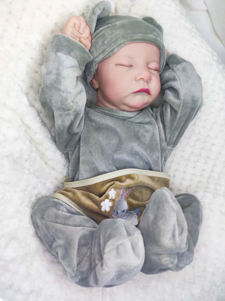 18-inch reborn doll with cloth body and hand-painted vinyl head wearing pink romper