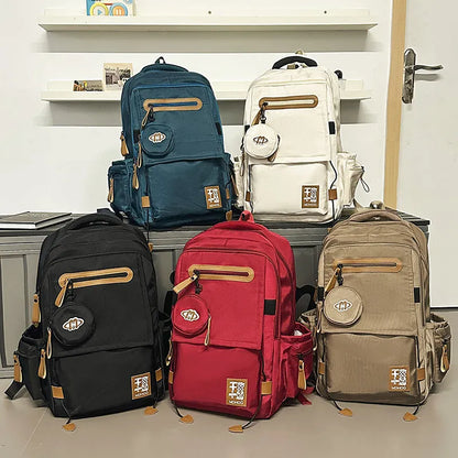 Large waterproof nylon travel backpack in blue with contrast stitching and 20-35 litre capacity