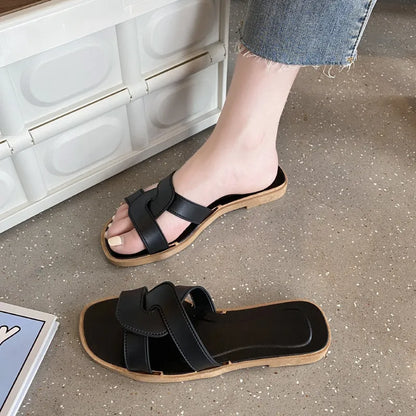 Women's PVC toe ring slippers with a cross strap in milky white, shown from a side angle.
