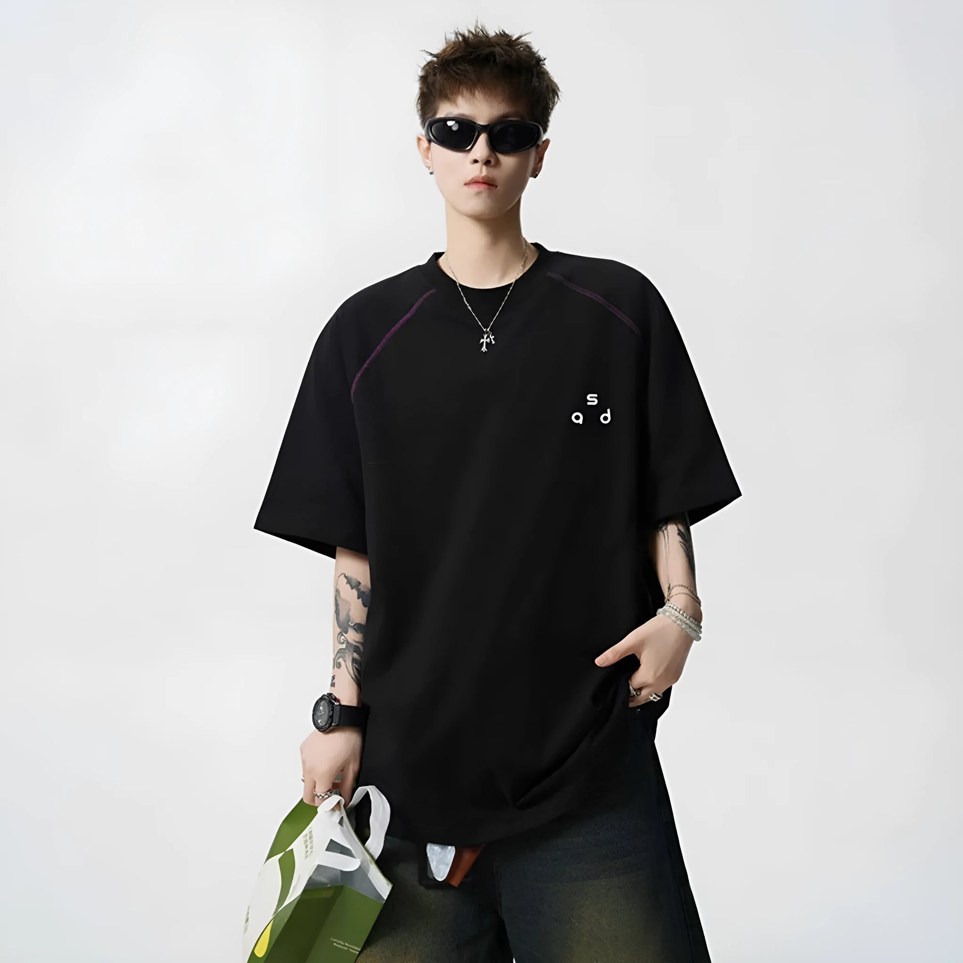 Black loose fit cotton T-shirt with white letter print on front, short sleeves and round neck.