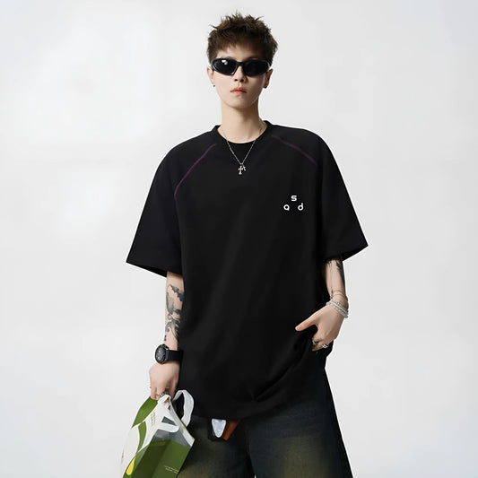 Black loose fit cotton T-shirt with white letter print on front, short sleeves and round neck.
