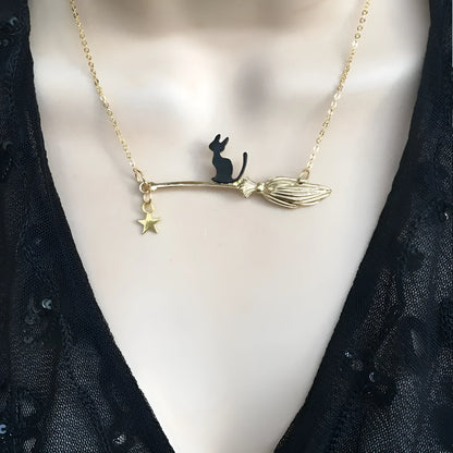 Black cat pendant necklace on a chain, available in silver and gold finishes.