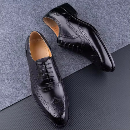 Men's purple leather Oxford shoes with hand-carved design and pointed toe on a rubber sole.