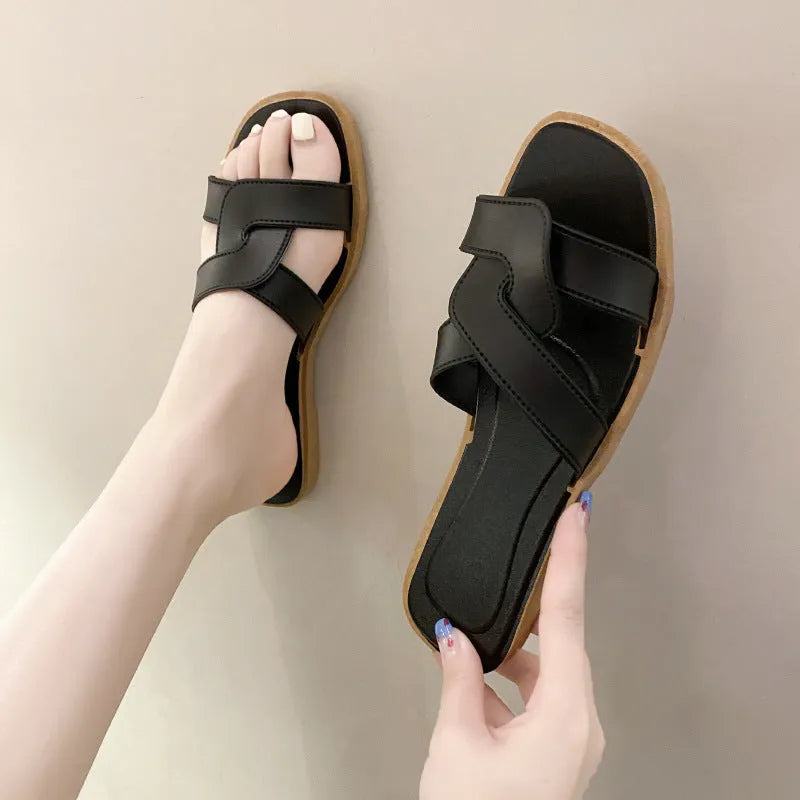 Women's PVC toe ring slippers with a cross strap in milky white, shown from a side angle.