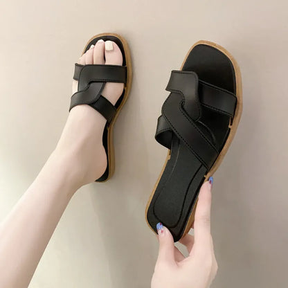 Women's PVC toe ring slippers with a cross strap in milky white, shown from a side angle.