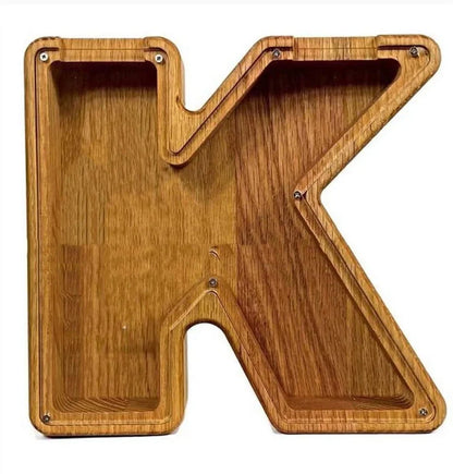 Handmade wooden letter piggy bank with personalised initial, showing 15cm height and 5cm coin slot for UK coins