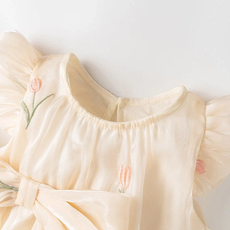 Apricot-coloured sleeveless baby jumpsuit with triangle design on hanger
