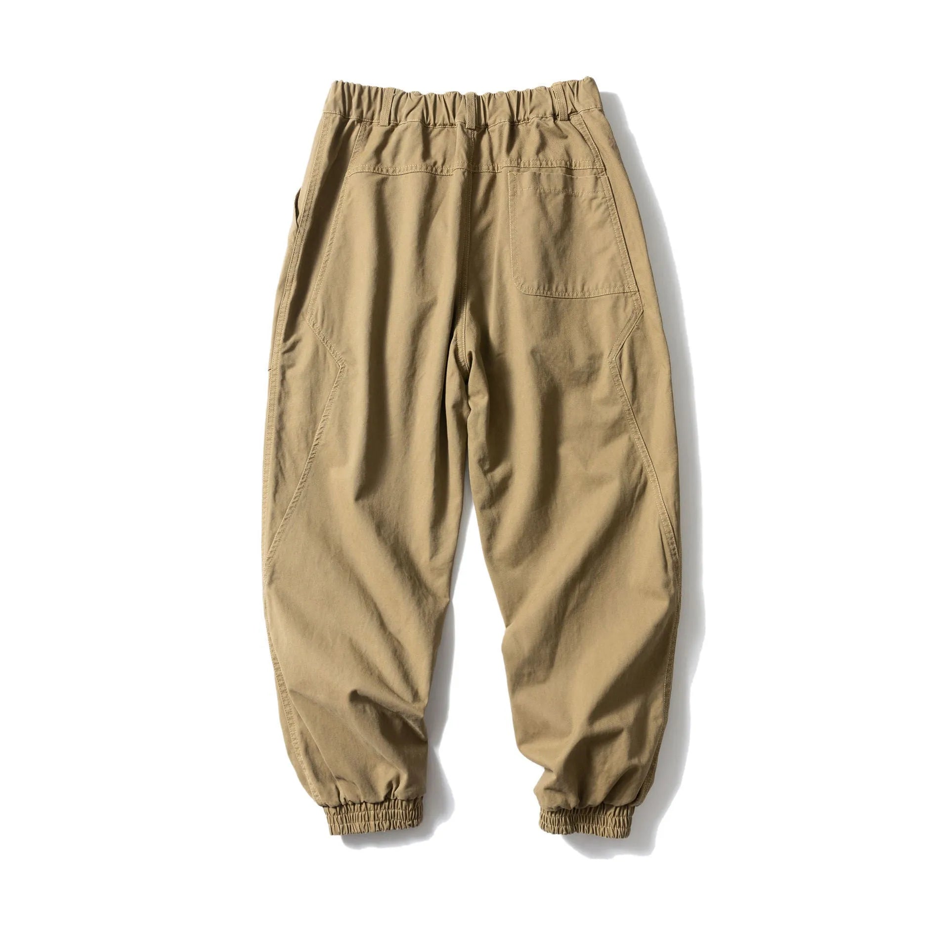 Black cotton casual pants with large pockets, tapered legs, and ankle ties on a hanger.