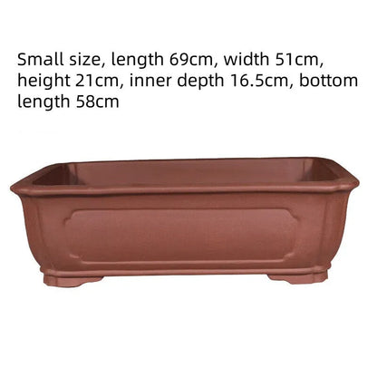 Handmade rectangular purple clay bonsai pot showing natural clay texture and rectangular shape with drainage