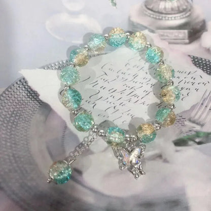 Chinese style glass bead bracelet with bamboo joint design on wrist.