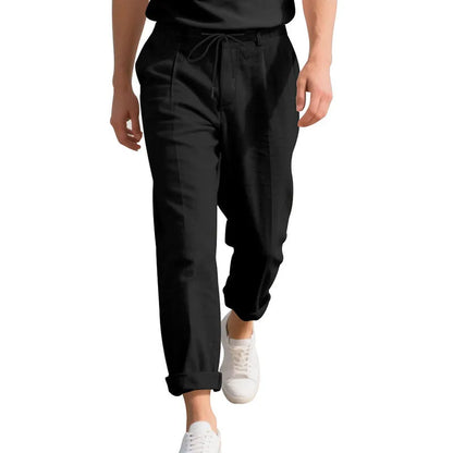 Men's light beige linen trousers with a loose straight leg and drawstring waist on a hanger.