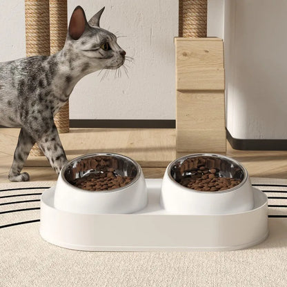 White elevated pet double bowl feeder with tilted food and water bowls on a non-slip stand.
