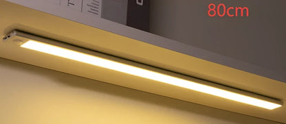 Silver LED inductive light strip, 40cm length, attached to shoe cabinet shelf with 3M adhesive