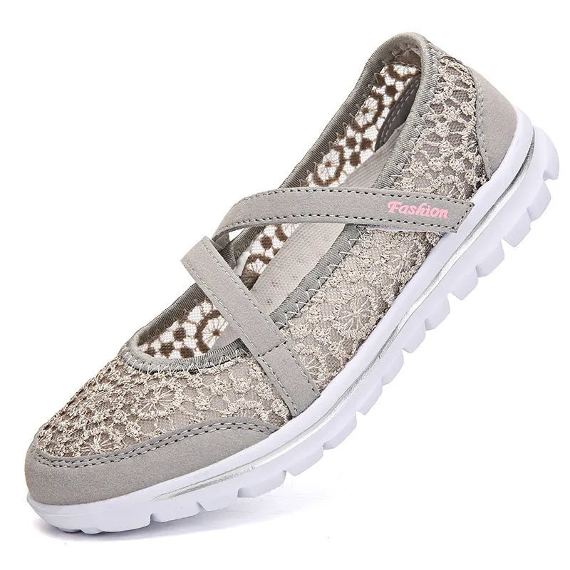 Women's beige mesh lace-up flat shoes with round toe and sewing line detail on a white background.