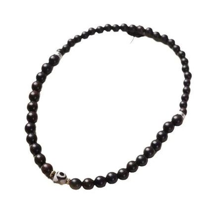 Dark ebony wood bracelet with Tibetan bead design showing two brown circles, 8mm wide unisex accessory